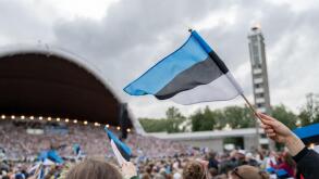 Tallinn, Estonia - July 6, 2025: Estonian Song and Dance Festival. Wide view from audience side shows song festival grounds arch with huge united choi