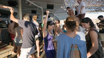 Mykonos, Greece. Tourists dancing at the Tropicana Club on Paradise Beach