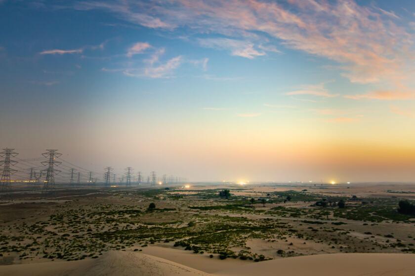 High voltage electric tower on sunrise time near Al Hofuf - Saudi Arabia.