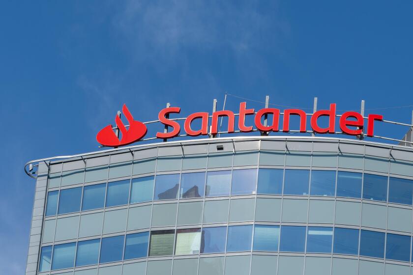 Close up of Santander Bank logo and sign on the office building in Warsaw, Poland.