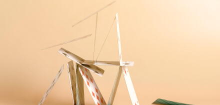 Crashed house of cards. Falling cards on beige background