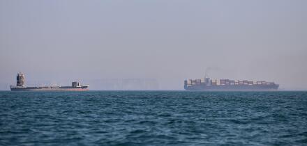 A container ship, right, and a cargo vessel are seen in the Strait of Hormuz off Bandar Abbas, Iran, Wednesday, June 17, 2026. (Amirhosein Khorgooi/ISNA via AP)