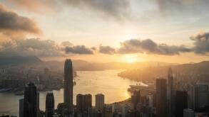 Sunrise over Hong Kong Victoria Harbor from Victoria Peak with Hong Kong and Kowloon below.