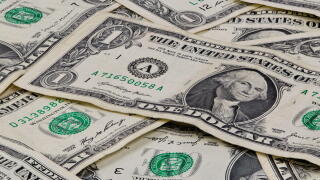 Pile of used US dollars partial cash bills money closeup finance economy concept.