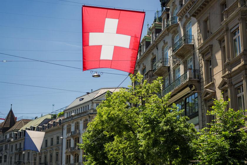Swiss flag flying in streets of Zurich, Switzerland