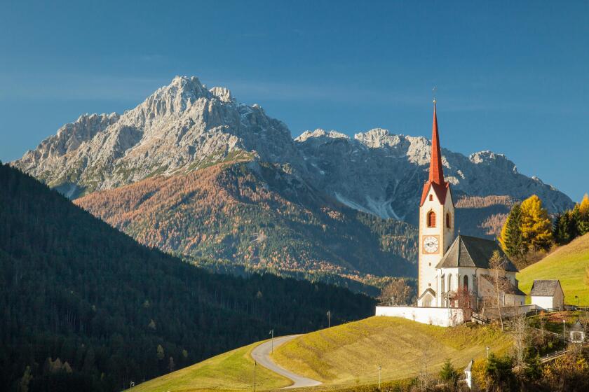 Autumn morning at the iconic church of Sankt Nikolaus in Winnebach, South Tyrol, Italy. Dolomites.
