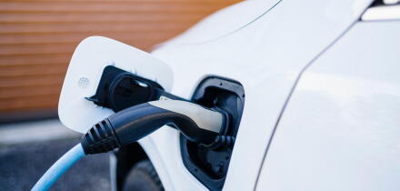Power cord charging electric car at station