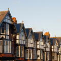 A row of large Edwardian style house rooftops in early morning sun at Scarborough
