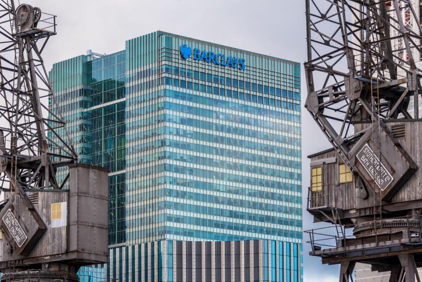 Barclays Head Office Canary Wharf London Docklands framed by old dockland cranes. Architects HOK International, Opened 2005.