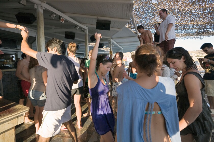 Mykonos, Greece. Tourists dancing at the Tropicana Club on Paradise Beach