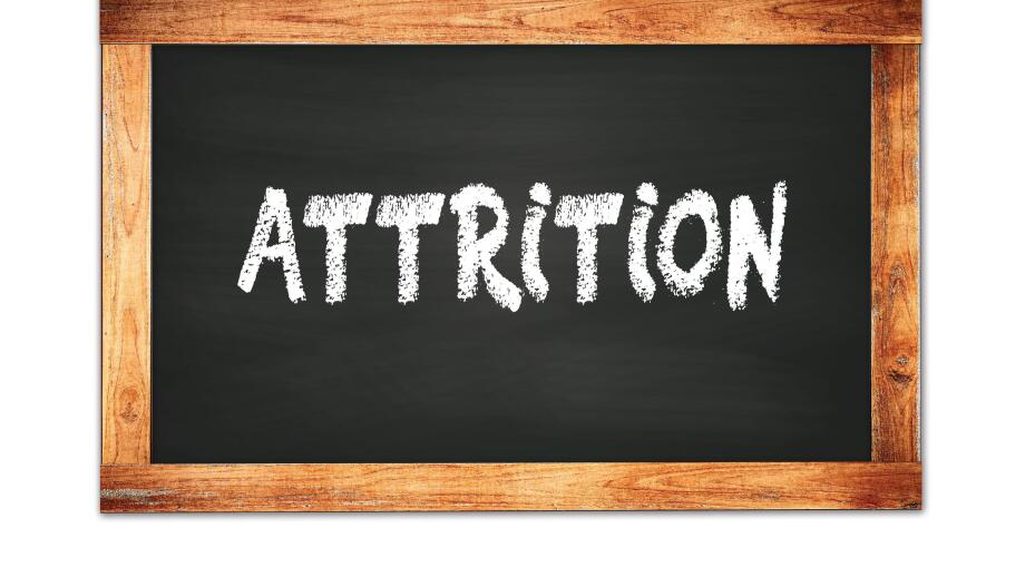 ATTRITION text written on black wooden frame school blackboard.