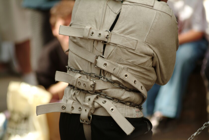 straight jacket street entertainer mad looney mental health handcuff tied up chain lock locked key strap escapologist escape jai