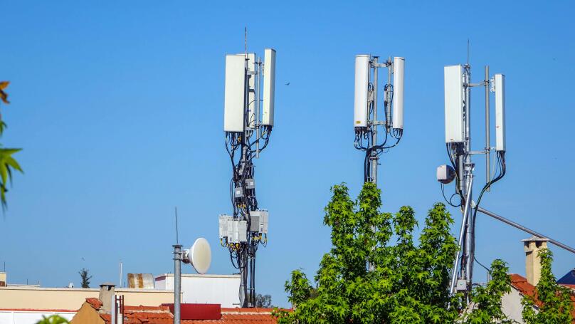 Mobile phone masts above rooftops, Fethiye, Turkey
