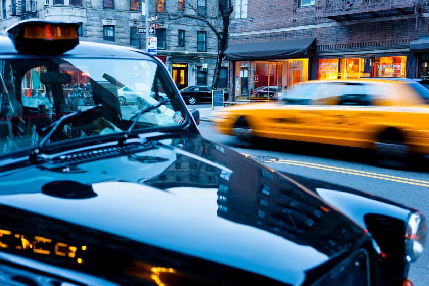 A typical taxi driving through New York, a London taxi parked on the roadside, New York City, NY, USA