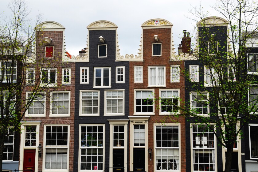 Typical Dutch houses along the canal in Amsterdam The Netherlands