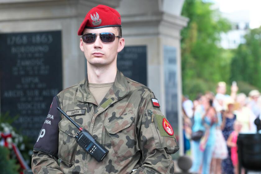Polish Army Military Police ( ZW ) soldier on duty beside the Tomb of the Unknown Soldier in Warsaw Poland
