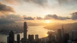 Sunrise over Hong Kong Victoria Harbor from Victoria Peak with Hong Kong and Kowloon below.