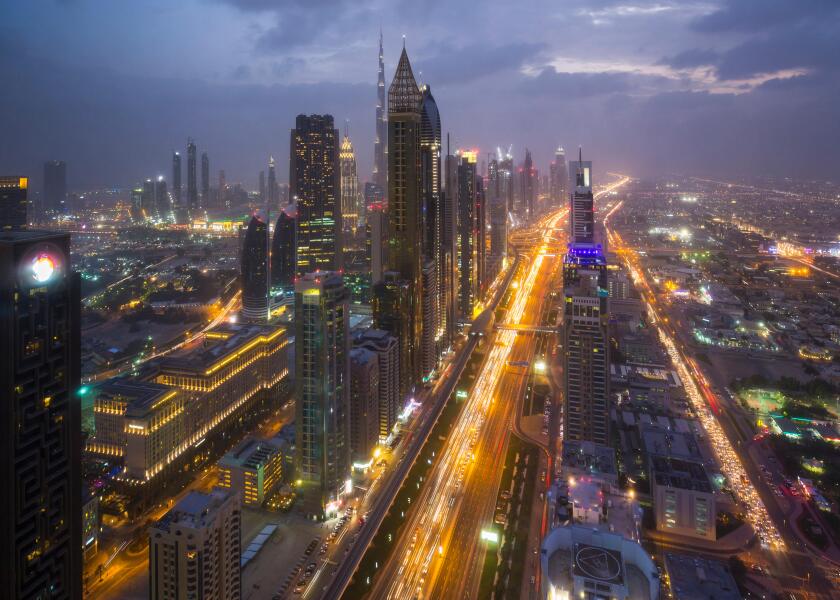 Skyscrapers along Sheikh Zayed Road at evening rush hour, Dubai, UAE
