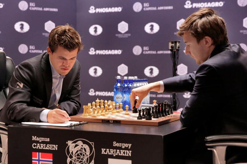 Sergey Karjakin, right, makes a move during round 8 of the World Chess Championship against Magnus Carlsen, in New York, Monday, Nov. 21, 2016. (AP Photo/Richard Drew)