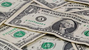 Pile of used US dollars partial cash bills money closeup finance economy concept.