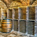 Traditional wine cellar featuring brick vaulted ceilings and stone flooring at Kingston Lacy country house, Kingston Lacy, Dorset, England, UK