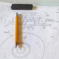 Drawing and pencil lies on a metal table at the factory