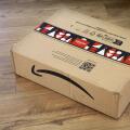 WARSAW, POLAND - DECEMBER 18, 2023: Amazon online store order box package delivered in Europe before Christmas, with holiday design tape.