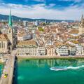 Aerial view of Zurich city center with famous Fraumunster and Sankt Peter Churches and river Limmat at Lake Zurich seen from Grossmunster, Switzerland