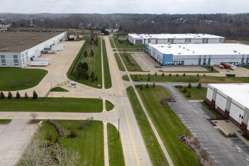 Aerial view of industrial warehouses and parking