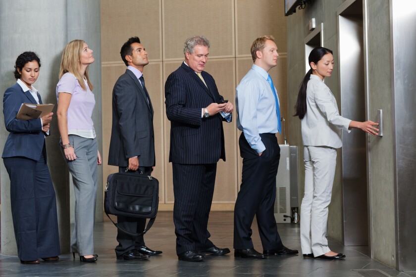 Businesspeople waiting in queue for elevator