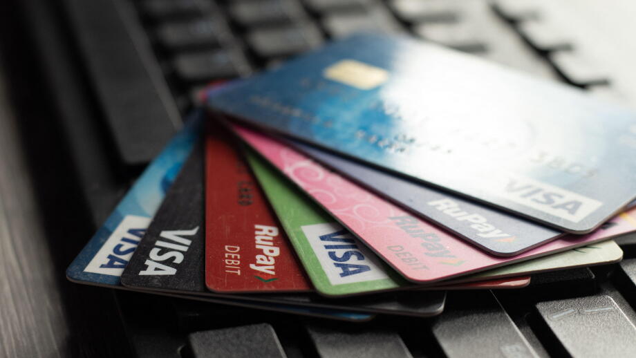 Selective focus on a group of credit and debit cards placed on a computer keyboard