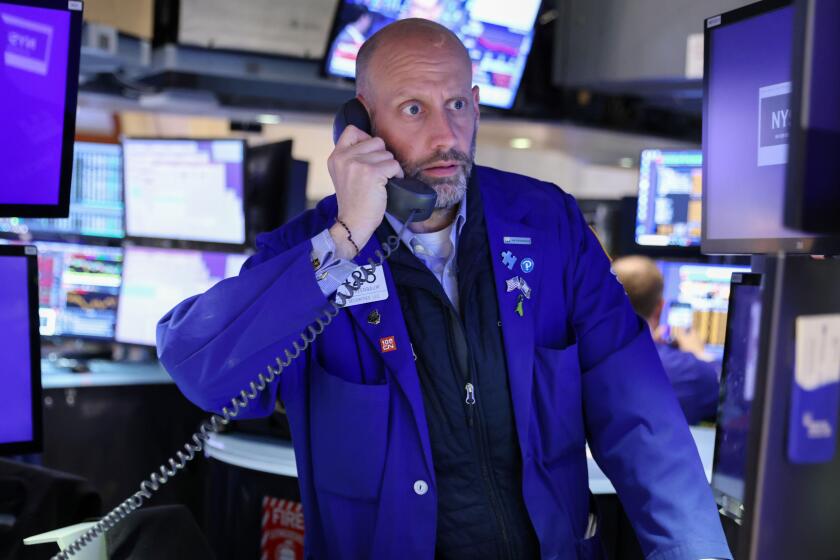 A trader works on the trading floor at the New York Stock Exchange (NYSE) in Manhattan, New York City, U.S., May 5, 2022. REUTERS/Andrew Kelly