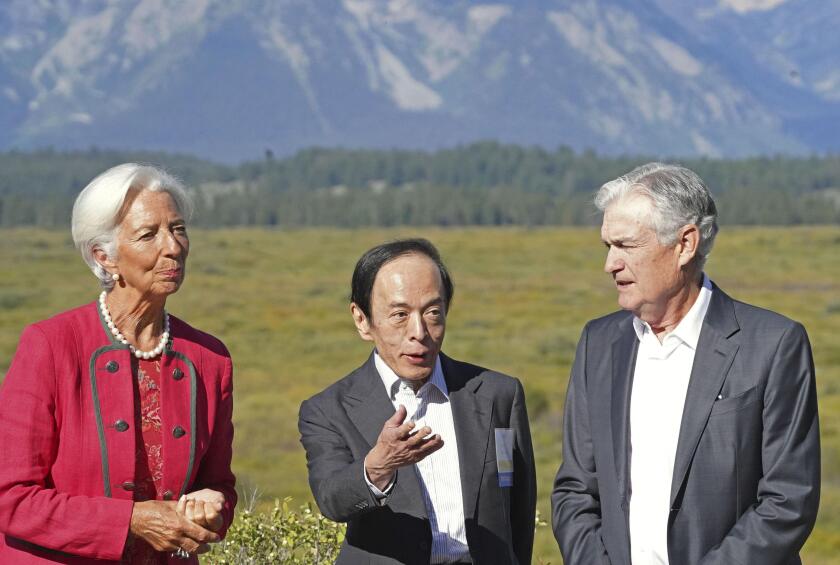 Bank of Japan Governor Kazuo Ueda (C) chats with U.S. Federal Reserve Chair Jerome Powell (R) at a villa used for an economic symposium in Jackson Hole, Wyoming, on Aug. 25, 2023. Standing next to Ueda is European Central Bank President Christine Lagarde.
