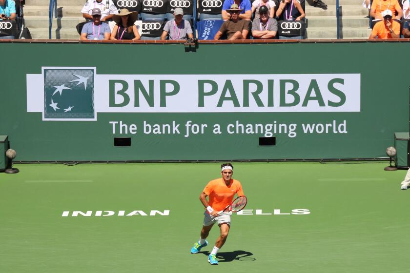 Indian Wells, California 20th March, 2015 Tennis player Roger Federer defeats Tomas Berdych in the Quarterfinal of the Men's Singles at the BNP Paribas Open (score 6-4 6-0). Photo: Larry Ellison in the brown shirt watches tennis player Roger Federer. Cred