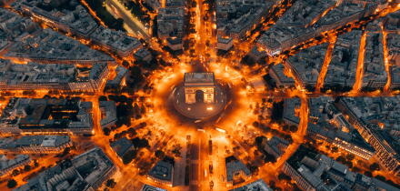 Aerial of the Arc de Triomphe in Paris, France at night