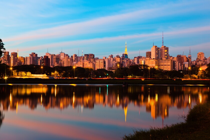 Sao Paulo skyline at sunset seen from Ibirapuera Park ( Parque Ibirapuera) a major urban park of the city, Brazil.