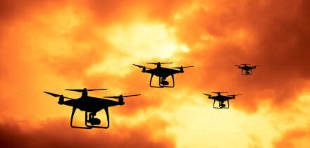silhouette of drones in formation