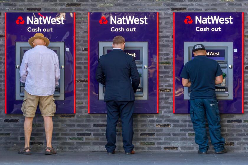 Men at the cash dispenser of NatWest Bank, London, Great Britain