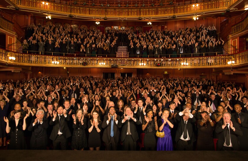 Audience applauding in theater