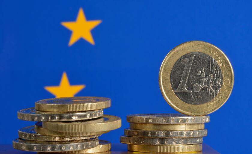 Euro coins with an European flag, symbolic image for the euro crisis