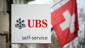A "Self Service" sign is hanging outside an ATM branch of Switzerland's largest bank UBS in Zurich, Switzerland.