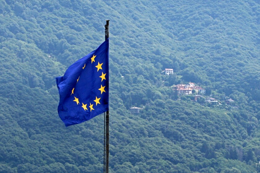 European Union Flag. Italian Alps in the background