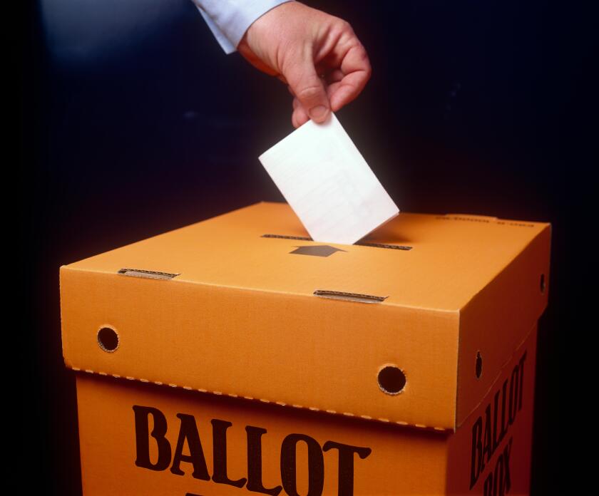 Voting paper being placed into a Ballot box, inside.