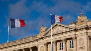 French flags in front of building in Paris, France