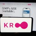 Stuttgart, Germany - 10-08-2025: Person holding cellphone with logo of British financial company Kroo Bank Ltd. on screen in front of webpage.