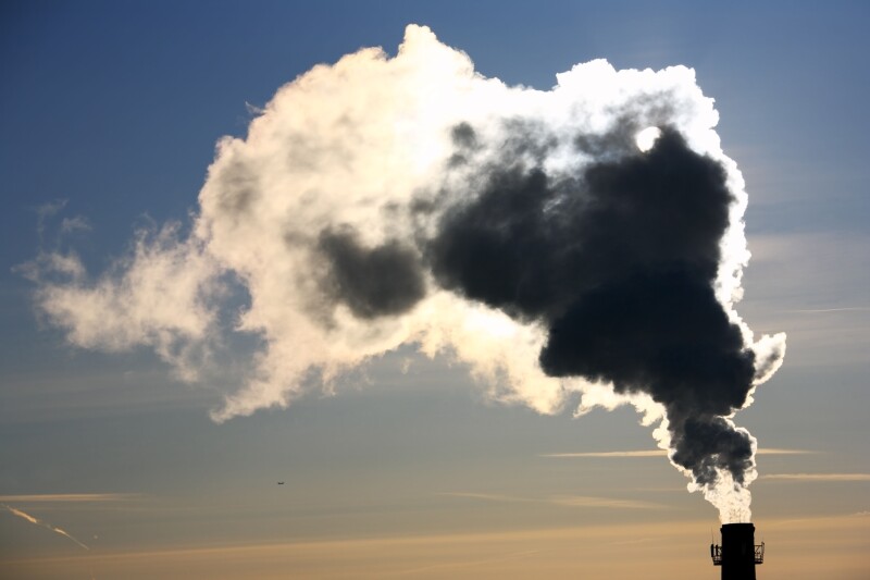 Pollution. Thick smoke from the chimney in winter morning.