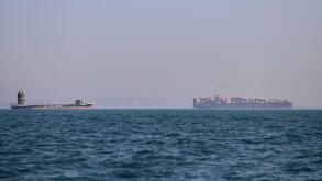 A container ship, right, and a cargo vessel are seen in the Strait of Hormuz off Bandar Abbas, Iran, Wednesday, June 17, 2026. (Amirhosein Khorgooi/ISNA via AP)
