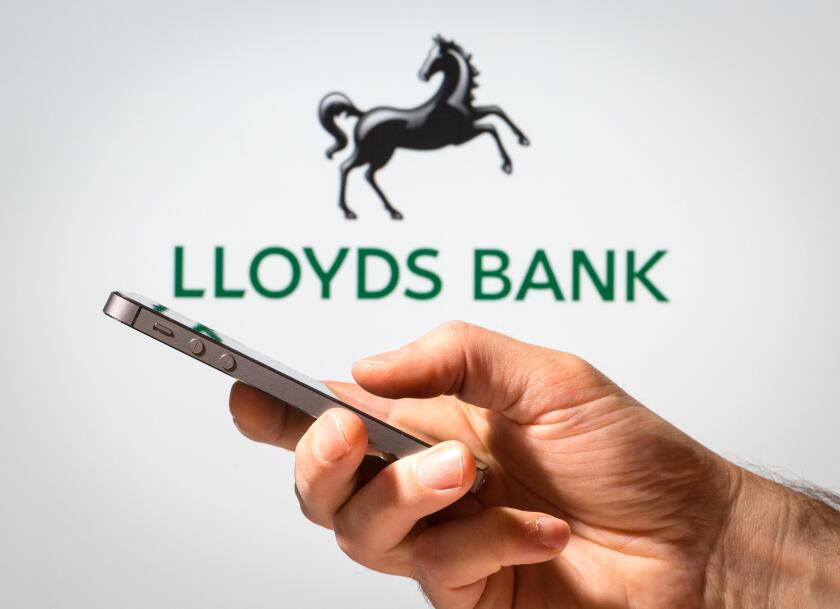 A man using Lloyds Bank online banking on his mobile phone