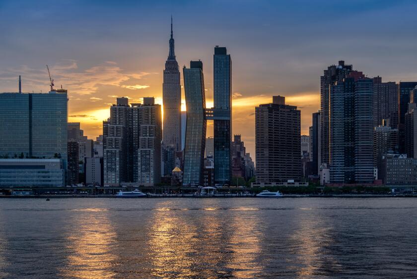The Manhattan Skyline and Empire State Building across the East River at sunset, Manhattan, New York, USA