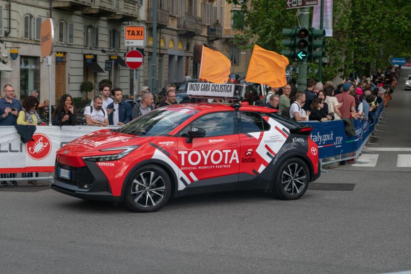Giro d'Italia sponsors teams at the great cycling race, with technical support teams and cars. pink sweater, tour of italy 2024, turin, italy, 4 may 2